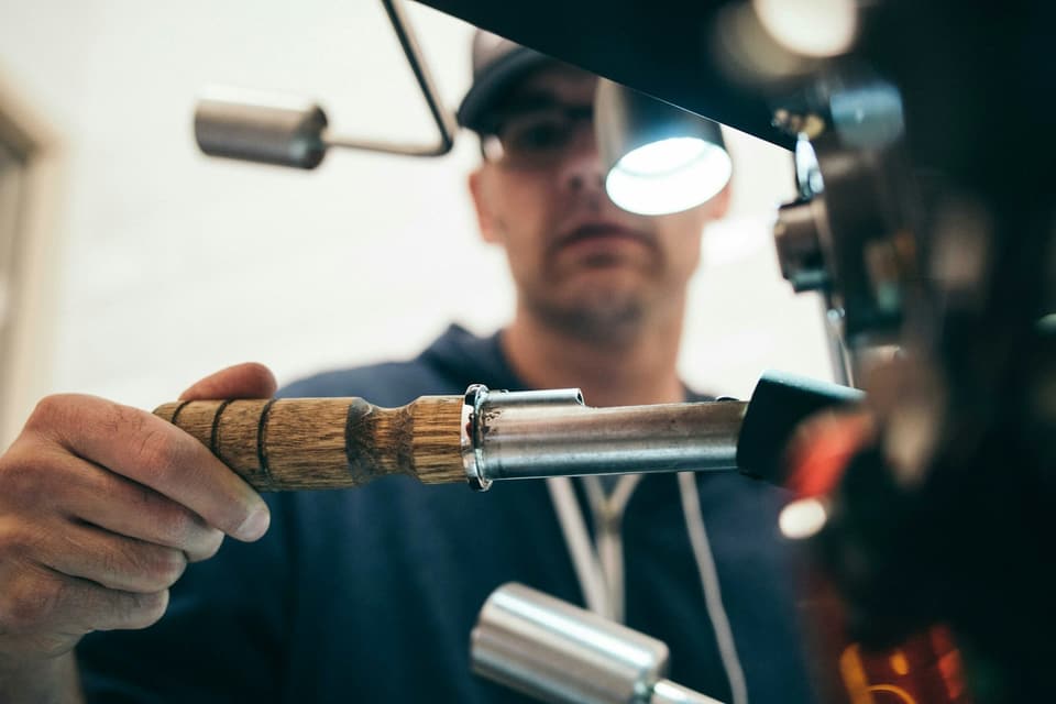 Technician inspecting equipment with a headlamp